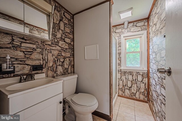 bathroom with vanity, a shower with shower door, crown molding, toilet, and tile patterned flooring