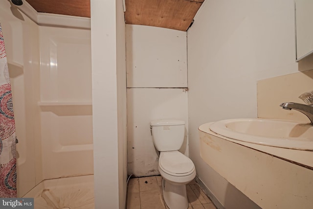 bathroom featuring tile patterned flooring and toilet