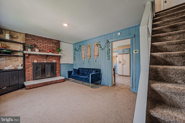 unfurnished living room with brick wall, carpet, and a fireplace