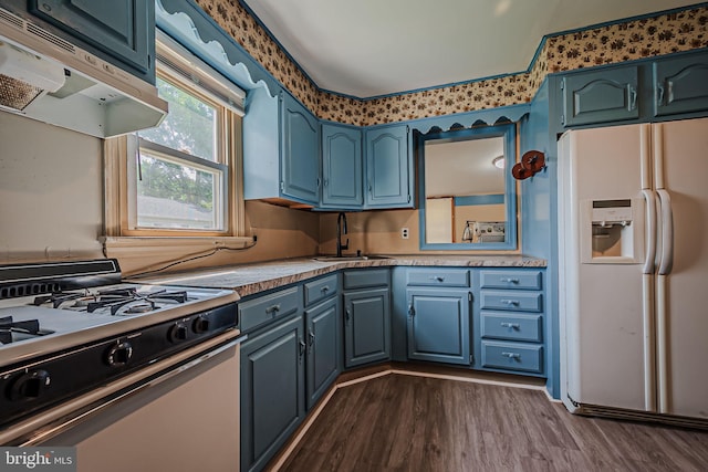 kitchen featuring extractor fan, sink, gas stove, dark hardwood / wood-style floors, and white fridge with ice dispenser