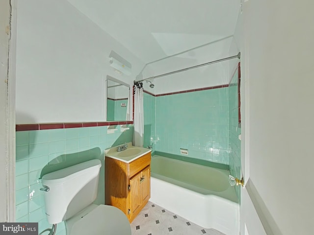 full bathroom with shower / tub combo with curtain, vanity, tile walls, and toilet