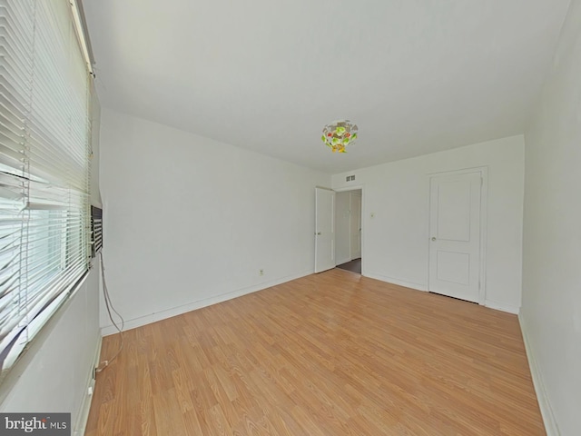 unfurnished room featuring light hardwood / wood-style floors