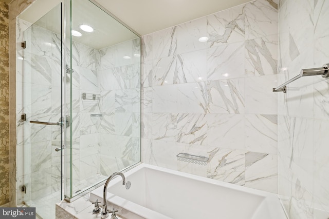 bathroom featuring shower with separate bathtub