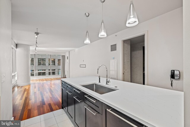 kitchen featuring light hardwood / wood-style floors, decorative light fixtures, and sink