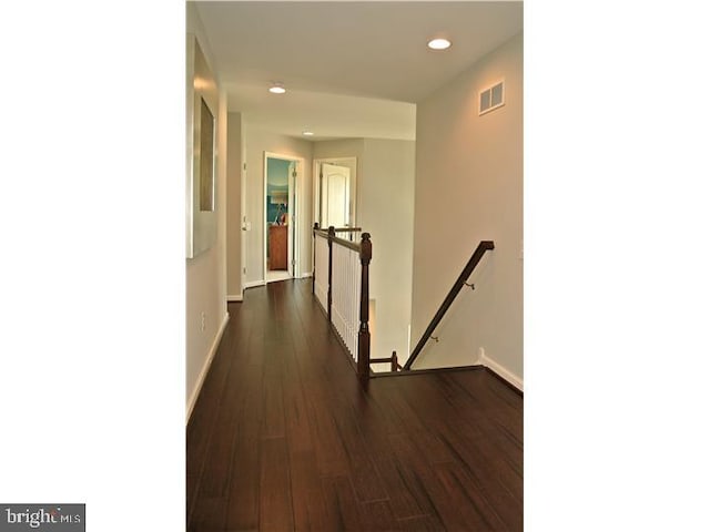 hallway with dark hardwood / wood-style flooring