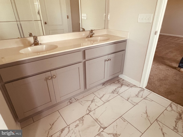 full bathroom featuring a sink, baseboards, marble finish floor, and double vanity