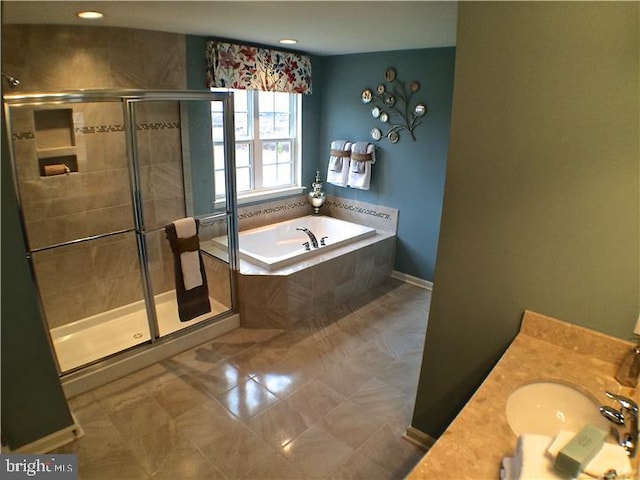 bathroom with tile patterned flooring, independent shower and bath, and vanity