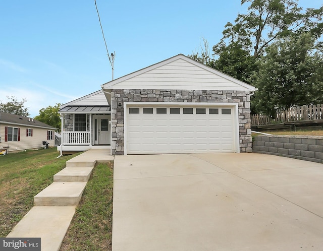 view of front of house with a garage, a front yard, and a porch