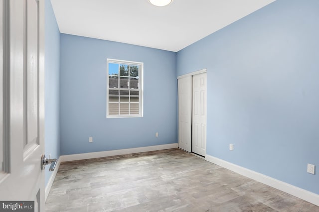 unfurnished room with light hardwood / wood-style flooring