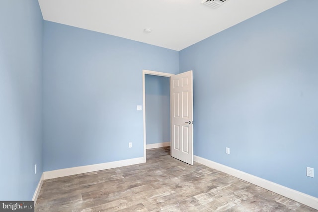 unfurnished room featuring light wood-type flooring