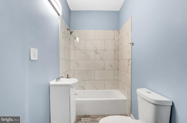 full bathroom featuring vanity, toilet, and tiled shower / bath combo