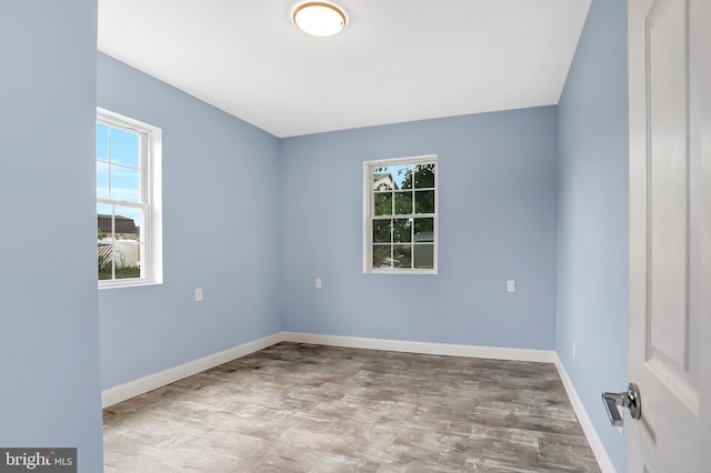 unfurnished room with hardwood / wood-style flooring