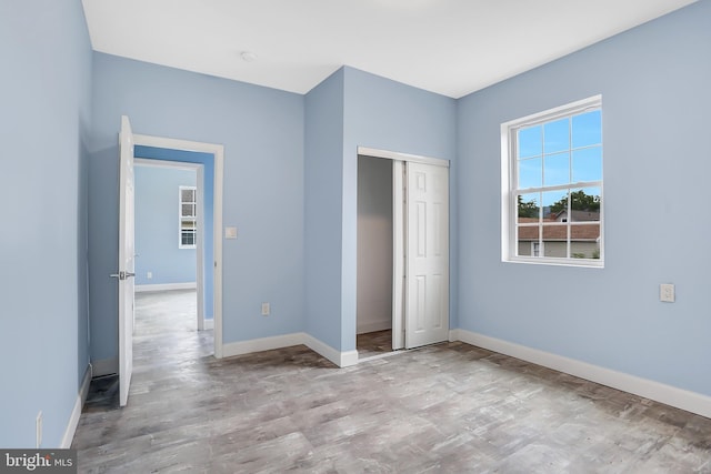 unfurnished bedroom with light hardwood / wood-style floors and a closet