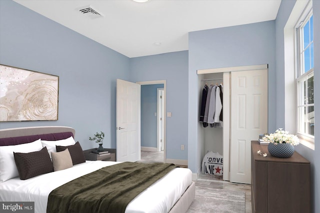 bedroom featuring light hardwood / wood-style flooring and a closet