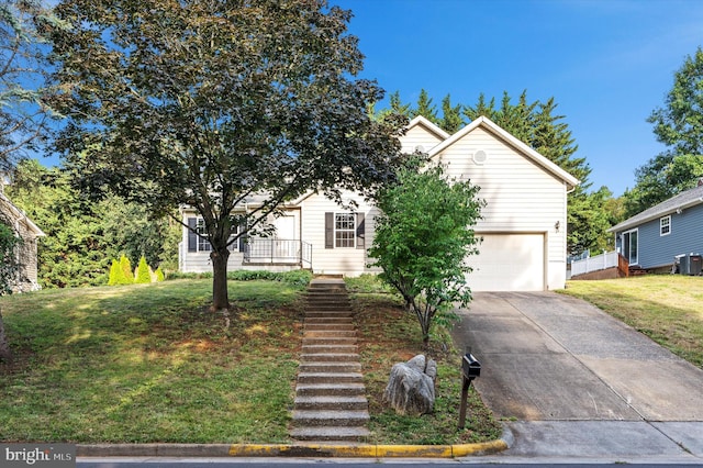 obstructed view of property with a front yard and a garage