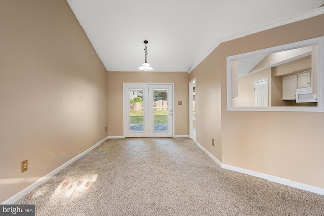 unfurnished room featuring ornamental molding, lofted ceiling, carpet flooring, and french doors