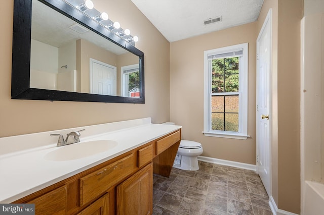 full bathroom featuring vanity, shower / bath combination, toilet, and a textured ceiling