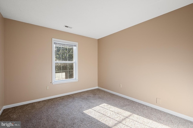 spare room featuring light colored carpet