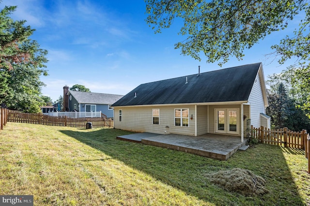 back of property featuring a lawn and a patio