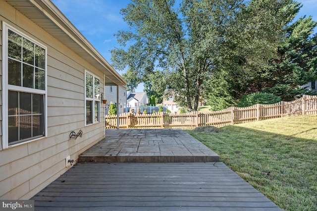 wooden deck featuring a yard