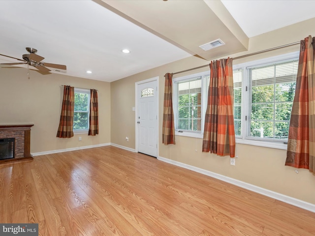 unfurnished living room featuring ceiling fan and light hardwood / wood-style flooring