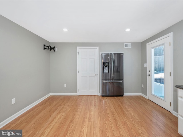 unfurnished living room with light wood-type flooring