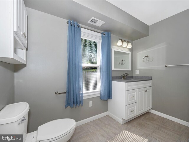 bathroom with vanity and toilet