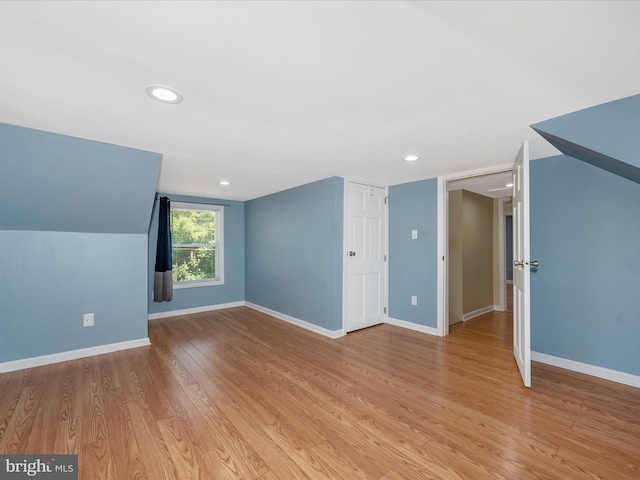 interior space featuring vaulted ceiling and light wood-type flooring