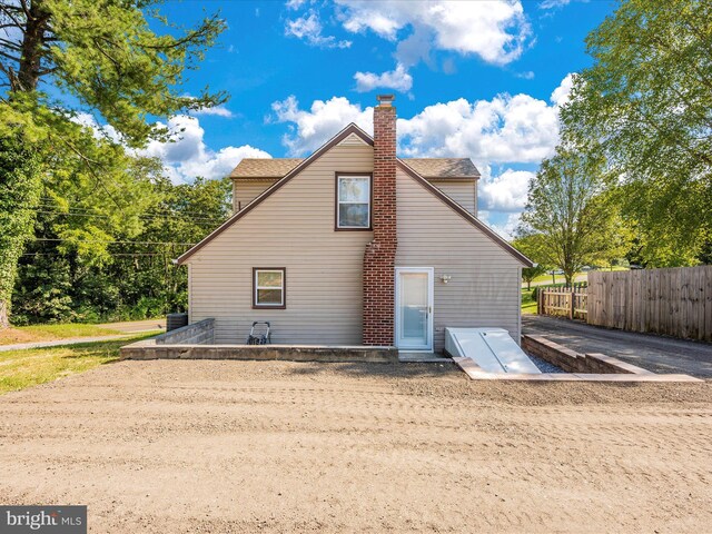 back of house with central AC