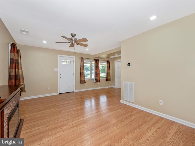 unfurnished living room with ceiling fan and light wood-type flooring