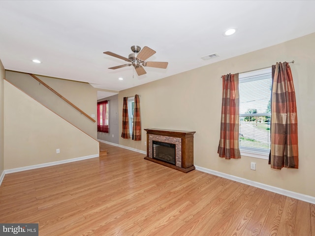 unfurnished living room featuring ceiling fan and light wood-type flooring