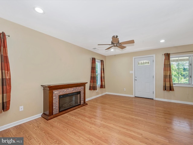 unfurnished living room featuring ceiling fan and light hardwood / wood-style flooring