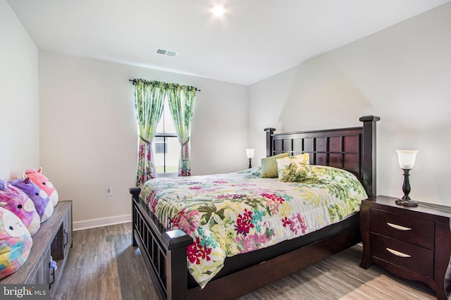 bedroom with light wood-type flooring, baseboards, and visible vents