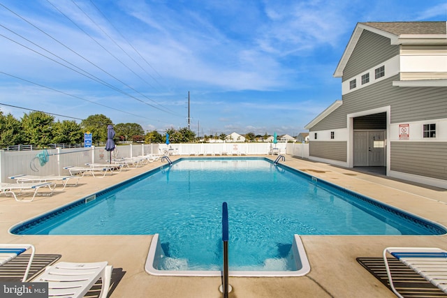 view of swimming pool featuring a patio area