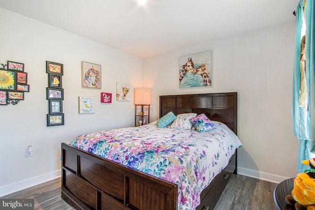 bedroom with dark wood-type flooring