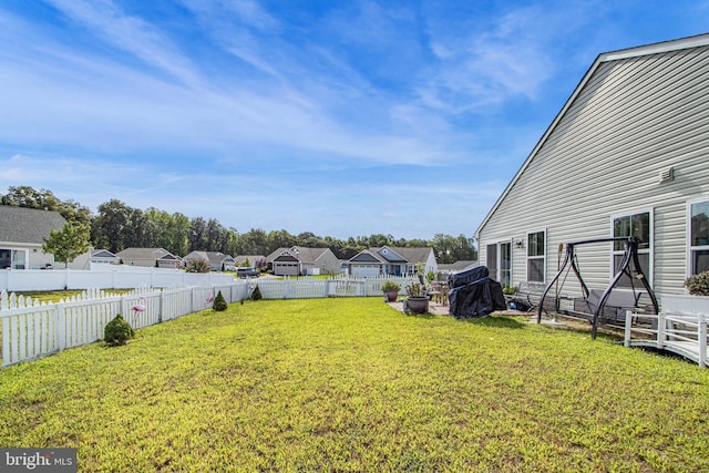 view of yard with a fenced backyard and a residential view