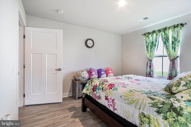 bedroom with wood-type flooring