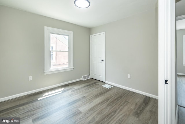 unfurnished room featuring hardwood / wood-style flooring