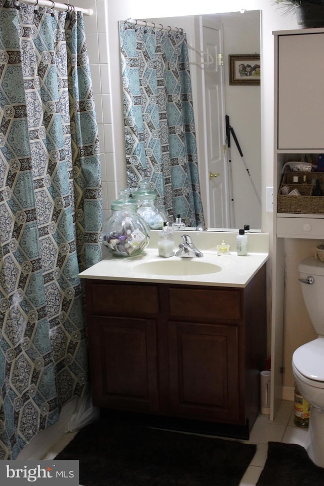 bathroom featuring a shower with shower curtain, vanity, toilet, and tile patterned flooring