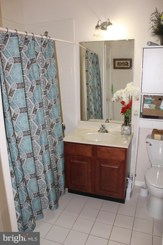 bathroom featuring tile patterned floors, toilet, and vanity