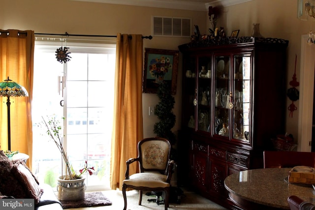 dining space with crown molding