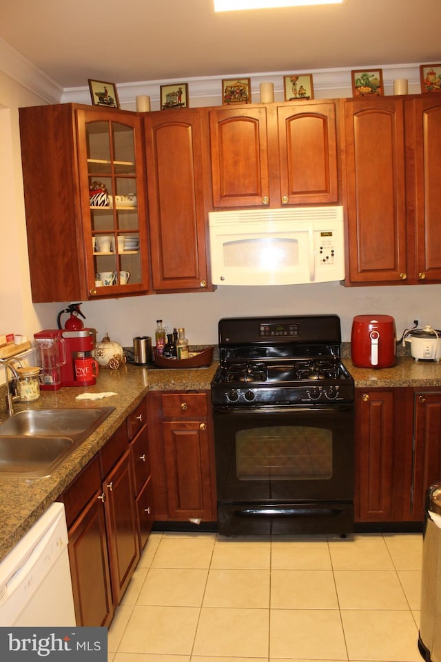 kitchen featuring crown molding, sink, white appliances, and light tile patterned floors