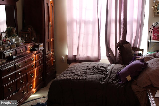 bedroom featuring light colored carpet