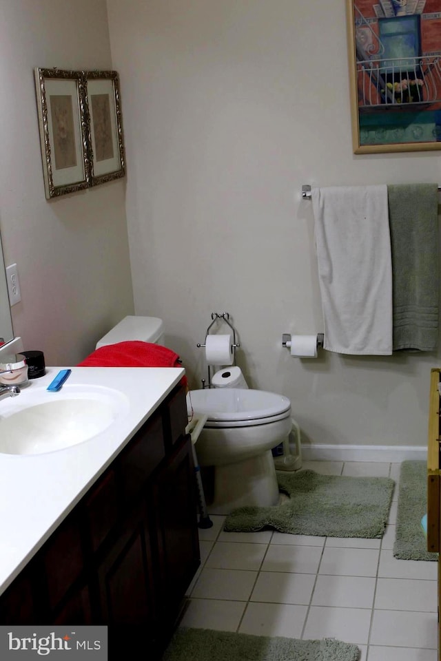 bathroom with tile patterned flooring, toilet, and vanity