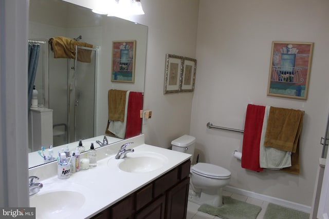 bathroom with vanity, a shower with shower door, tile patterned floors, and toilet