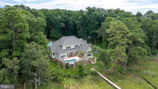 birds eye view of property with a view of trees