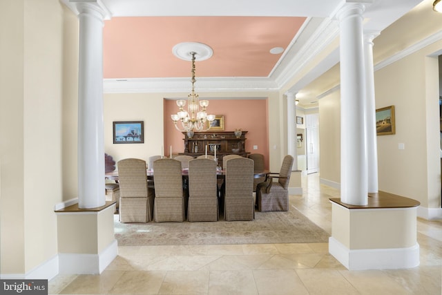 dining room with crown molding, an inviting chandelier, baseboards, and ornate columns