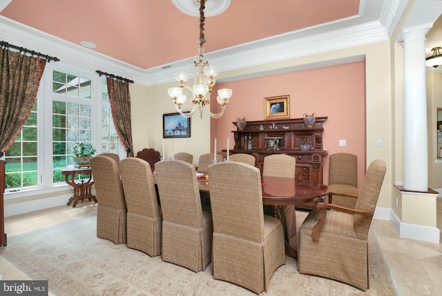 dining room featuring crown molding, a notable chandelier, decorative columns, light tile patterned flooring, and baseboards