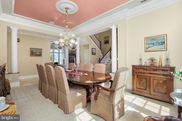 dining area featuring ornate columns, stairway, and crown molding