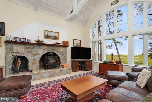 living area with a wood stove, wood ceiling, high vaulted ceiling, and beam ceiling